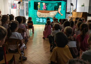 Dzieci oglądają przedstawienie teatralne.