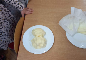 Masło samodzielnie wykonane przez dzieci leży na stole.