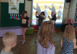 Dzieci tańczą w kole, według propozycji Pana Witka.