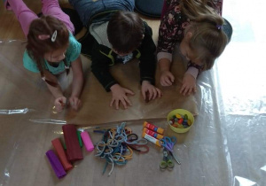 Dzieci wykonują prace plastyczne, zamieniają odrysowane dłonie w drzewa.