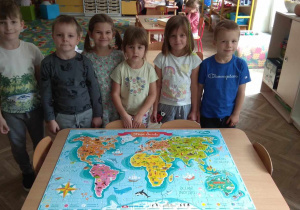Grupa 6 dzieci pozuje do zdjęcia obok ułożonych 168 elementowych puzzli.