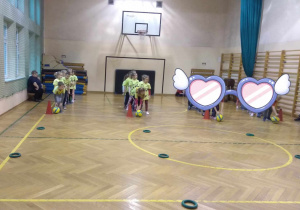 Dzieci uczestniczą w konkurencjach sportowych z piłką.