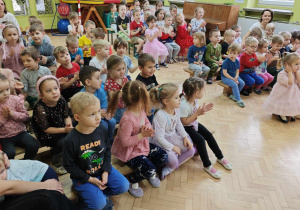 Dzieci nagradzają brawami występ artystyczny pana Jacka.