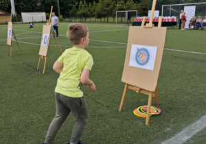 Dzieci z grupy zielonej w trakcie wykonywania konkurencji sportowych.