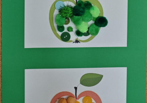 Na tablicy wiszą wypełnione guziczkami i pomponami szablony jabłek.