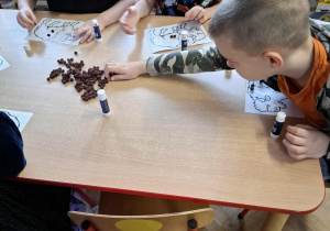 Dzieci wykonują pracę plastyczną.