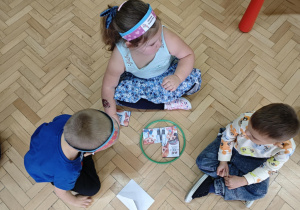 Dzieci w małych zespołach układają pocięte obrazki przedstawiające wybrane prawo.