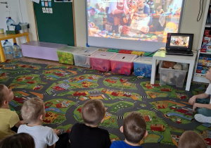 Dzieci oglądają film edukacyjny.