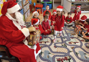 Mikołaj wręcza prezent dziecku