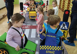 Dzieci wcielają się w rolę pojazdów i pieszych poruszających się w ruchu drogowym.