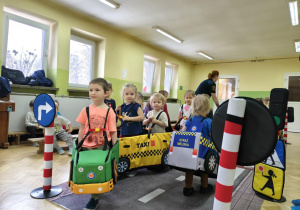 Dzieci uczestniczą w zabawie dotyczącej ruchu drogowego.