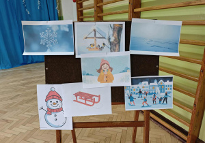 Na tablicy wiszą obrazki przedstawiające rozwiązania zimowych zagadek.