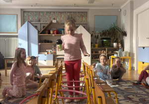 Dzieci biorą udział w zabawie ruchowej.