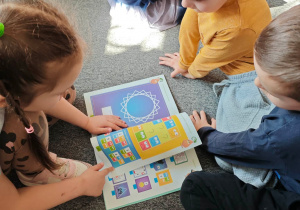 Dzieci poszukują wiosny w dostępnym księgozbiorze.