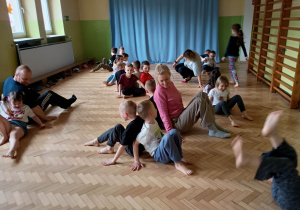 Dzieci i Rodzice ćwiczą podczas zajęć ruchowych.