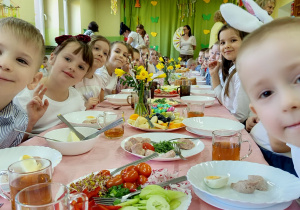 Dzieci jedzą wielkanocne śniadanie.