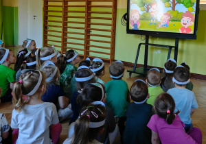 Dzieci oglądają film edukacyjny.