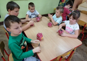 Dzieci z gr. II wykonują pracę plastyczno - techniczną "Jabłka"